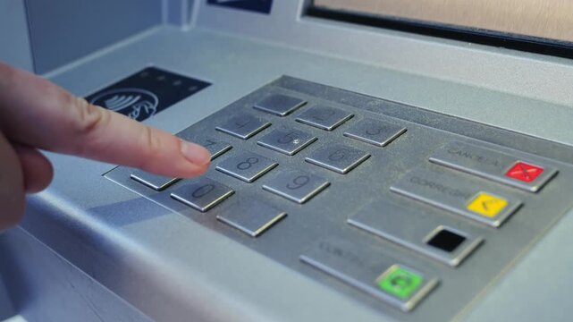 Close-up of hand entering PIN code at ATM, concept of banking security and transactions. High quality 4k footage