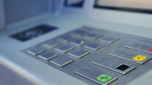 Close up of hand applying card to ATM machine to withdraw cash, banking transaction concept. High quality 4k footage