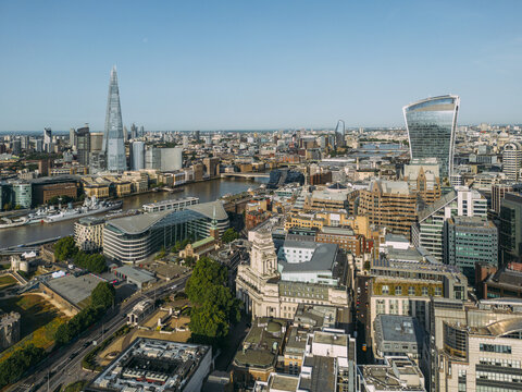 Aerial view of the Shard and the Walkie Talkie building stand tall amidst the urban sprawl, bisected by the winding Thames, London, United Kingdom.