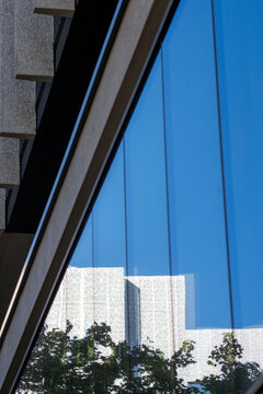 Abstract modern architecture geometry in blue glass reflections on facade window with strong lines for a crisp minimal urban study