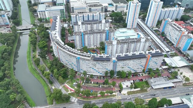 Aerial view of the distinctive curved residential complex along a serene river, showcasing a vibrant urban tapestry of high-rises and lush green spaces, Singapore, Singapore, Singapore.