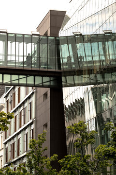 Glass walkway spans a modern bridge in an urban skyline where architecture and clean lines define structure and connection across the city