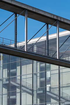 Glass and steel walkway on a modern bridge shows urban architecture with clean lines and a strong structure built for connection and passage