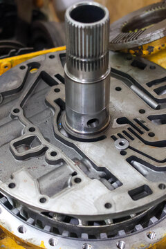 ​A detailed close-up of a front support assembly for an Allison 700 series automatic transmission, showing the intricate hydraulic channels and metal construction.