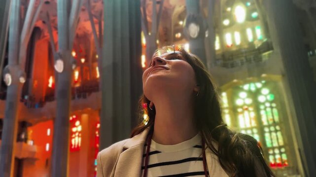 A tourist inside a museum or historical building looks around and admires the architecture. High quality 4k footage