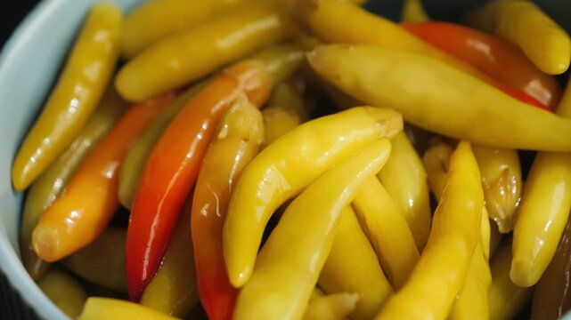 Pickled elongated spicy Turkish peppers, Yakan Biber, in vinegar brine, crispy hot appetizer with traditional flavor. High quality 4k footage