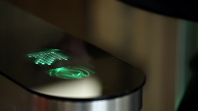 Mobile phone interacting with access control terminal in office lobby. Concept.

