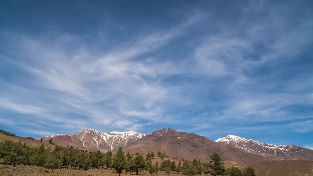 Snowbound mountain valley in dense mist and clouds, natural travel time lapse scene