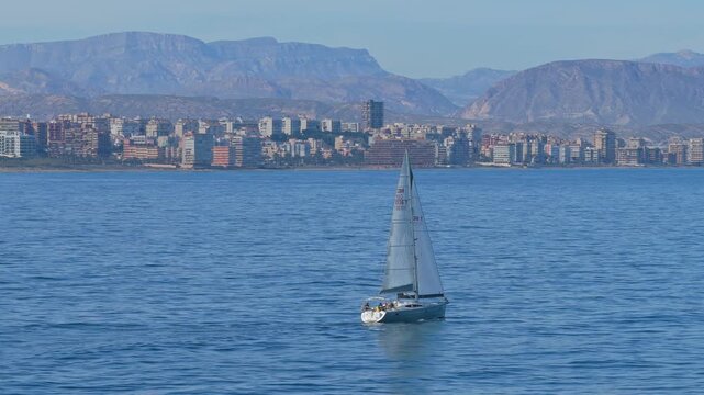 Sailboat navigating the mediterranean sea off alicante coast