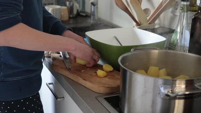 Preparing fresh potatoes for cooking in a modern kitchen setting