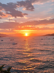 Obraz premium Gorgeous sunset casts warm hues across calm sea surface with gentle ripples reflecting the sun's glow