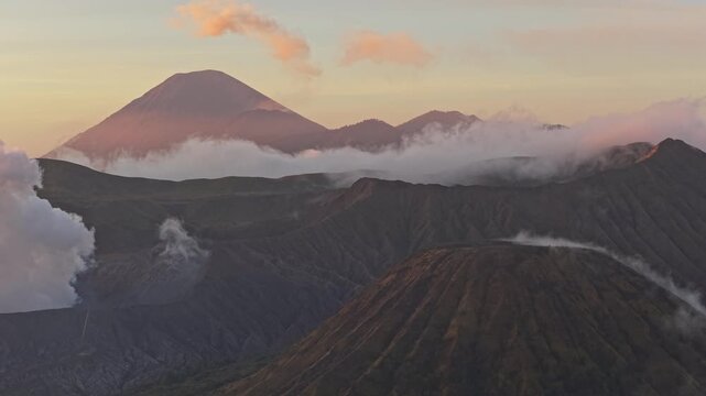 Smoking mount bromo volcano during an ethereal indonesian sunrise