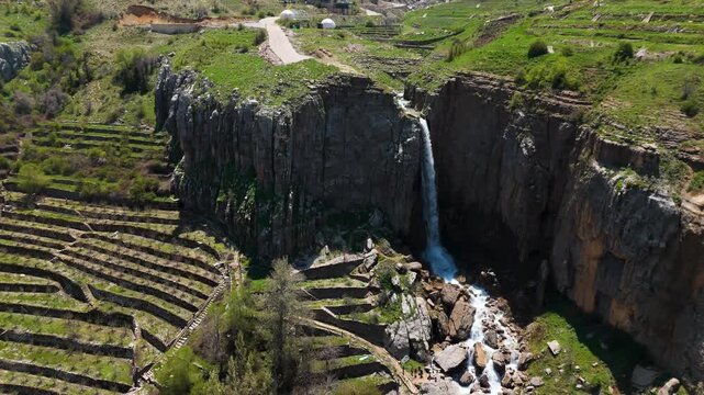 Aerial shot of a waterfall in the mountains of Faraya with rocky cliffs and flowing water