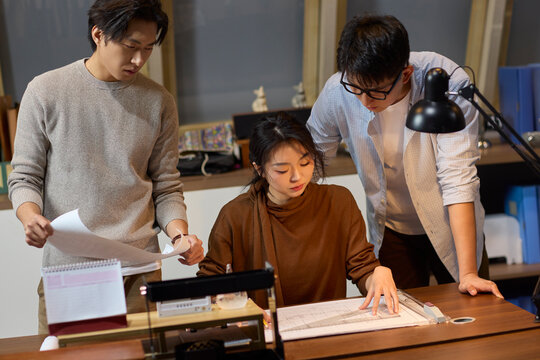 The team works late into the evening to meet a deadline
