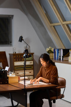 Businesswoman works late into the evening to meet a deadline