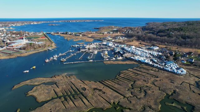 Drone view of marina full of boats and boatyard in Gloucester, Massachusetts, USA. Aerial forward