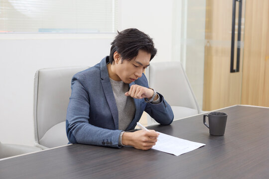 A dedicated employee focuses on work at their office desk