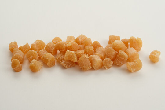 Dried scallop pieces close-up on white background as culinary ingredient