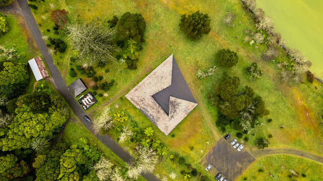 Aerial view of the modern building with dark angular roof contrasting with the lush green surroundings, creating a striking architectural statement, Ponta Delgada, Azores, Portugal.