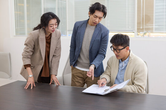A group of professionals collaborates during a meeting at the office