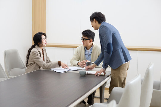Colleagues focus during a meeting in the conference room
