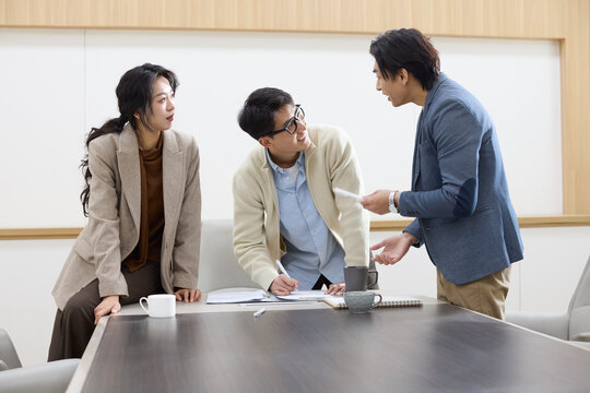 Colleagues focus during a meeting in the conference room