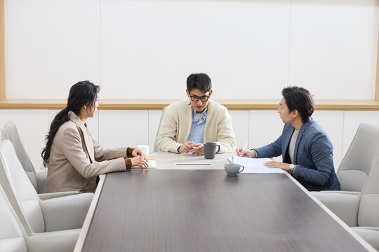 Colleagues focus during a meeting in the conference room