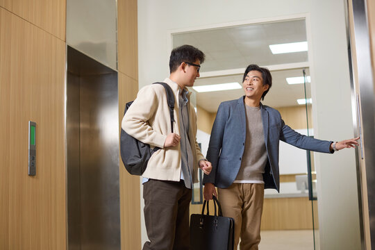Business people share an elevator ride in their workplace