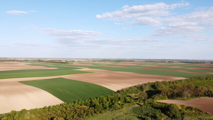 Naklejka premium Aerial Drone View of Patchwork Agricultural Fields and Farmland Landscape in Spring