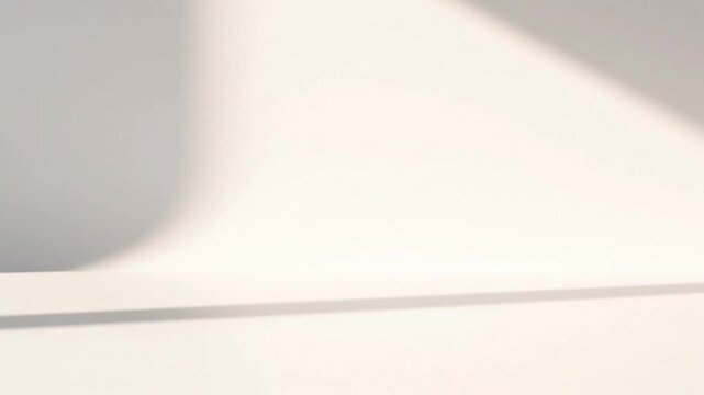 Clean minimal background with a soft light sweep moving smoothly across the surface. This seamless loop animation features subtle lighting transitions and elegant motion, creating a modern corporate 