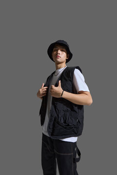A young man with cool confidence and chic style