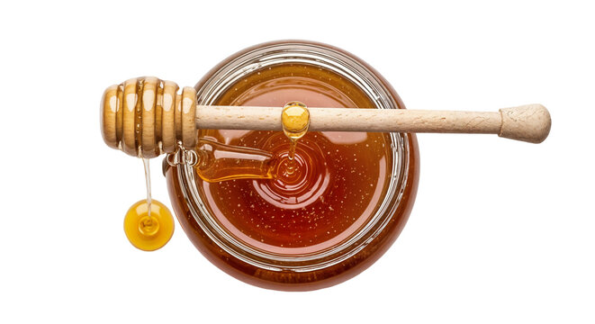 honey in glass jar with wooden dipper