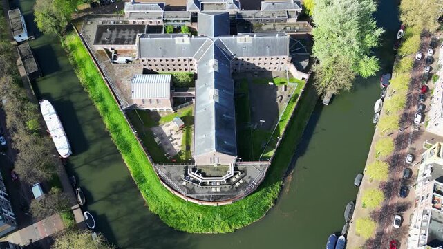 High angle top down aerial view of Wolvenplein prison architecture and canal in Utrecht 