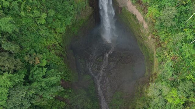 Aerial top down view revealing indonesian waterfall in jungle
