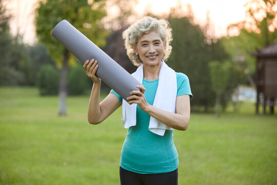 Happy senior woman exercising in a park