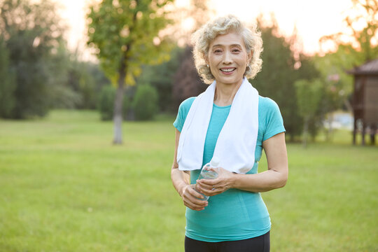 Happy senior woman exercising in a park