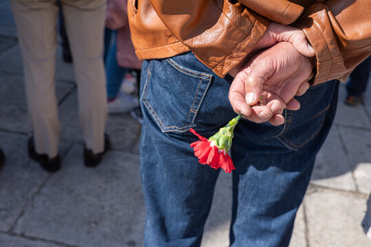 Man holding red carnation in Portugal The Concept of memory