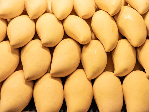 Close up of fresh ripe yellow tropical mangoes
