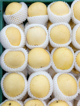 Close up of fresh ripe yellow Asian pears on display
