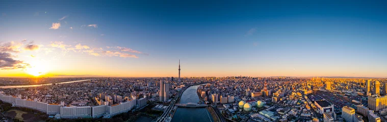 Aerial panorama view by drone of Tokyo Cityscape with Tokyo Sky Tree visible in Tokyo city, Japan on sunrise. Panoramic Dawn view of Tokyo city. Senso-Ji Temple with Sumida river in Japan. © FocusStocker