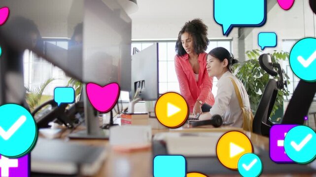 Mentor pointing and staffer typing, causing social icons flooding desk to show marketing work