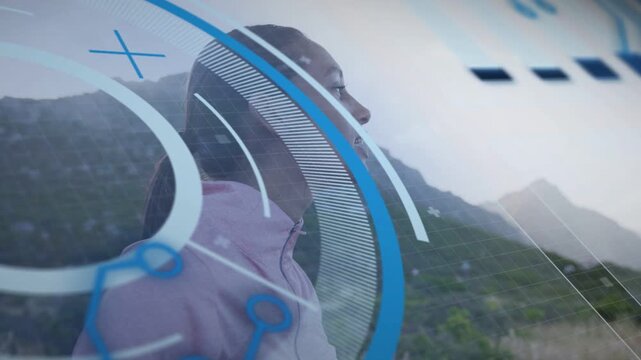 Woman standing hillside activating workout app, HUD rings sweeping across profile visualizing data