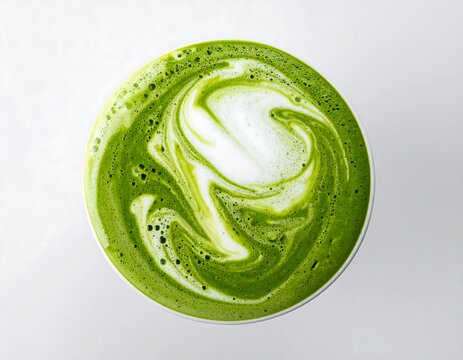 Concentric ripple of green matcha liquid on white milk surface, top down tea latte impact isolated on white