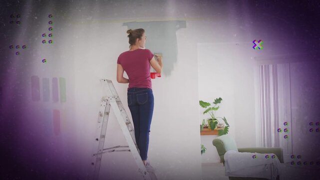 Woman dipping roller in red paint on ladder repainting wall to renew room overlays showing progress