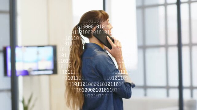 Office woman answering business call, pacing open office while binary overlay pulsing around phone