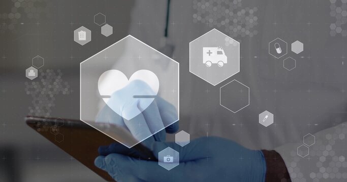 Tapping tablet senior doctor working in clinic wearing lab coat, blue gloves, hex icons