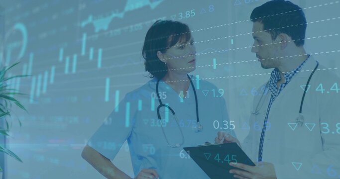 Talking nurse in blue scrubs and doctor in white coat checking clipboard, stethoscopes, graph