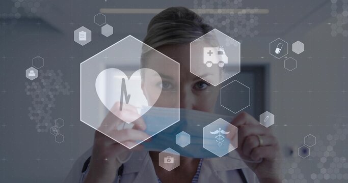Holding doctor preparing surgical mask in clinic showing stethoscope, ring, lab coat, medical icons