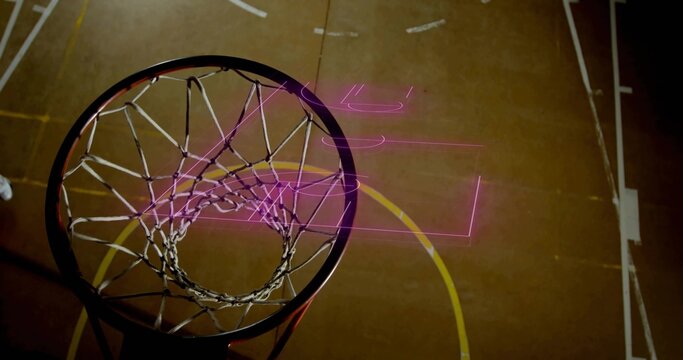 Framing metal basketball rim and nylon net hanging over gym court with painted lines, neon overlays
