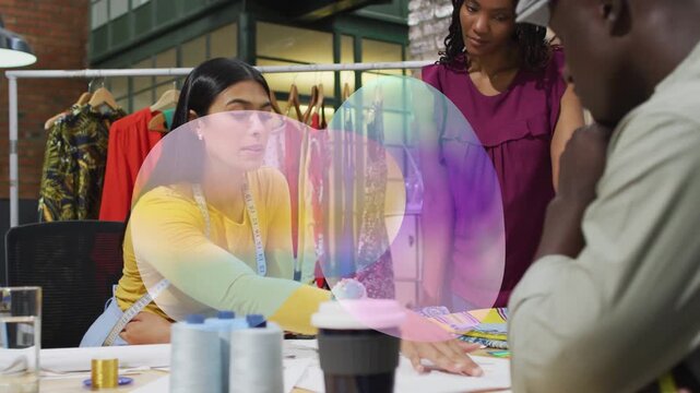 Seated woman leaning and pointing at swatches, leading fashion design while overlay showing tape